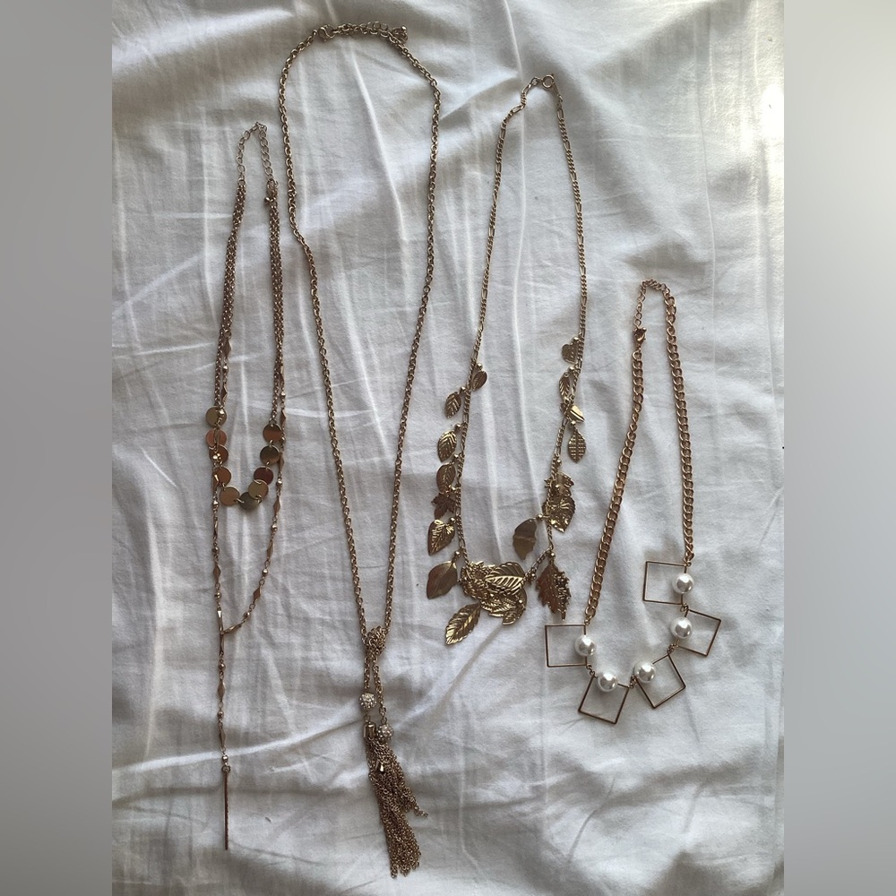 Four Gold-tone Necklaces In. Different Shapes And Sizes
